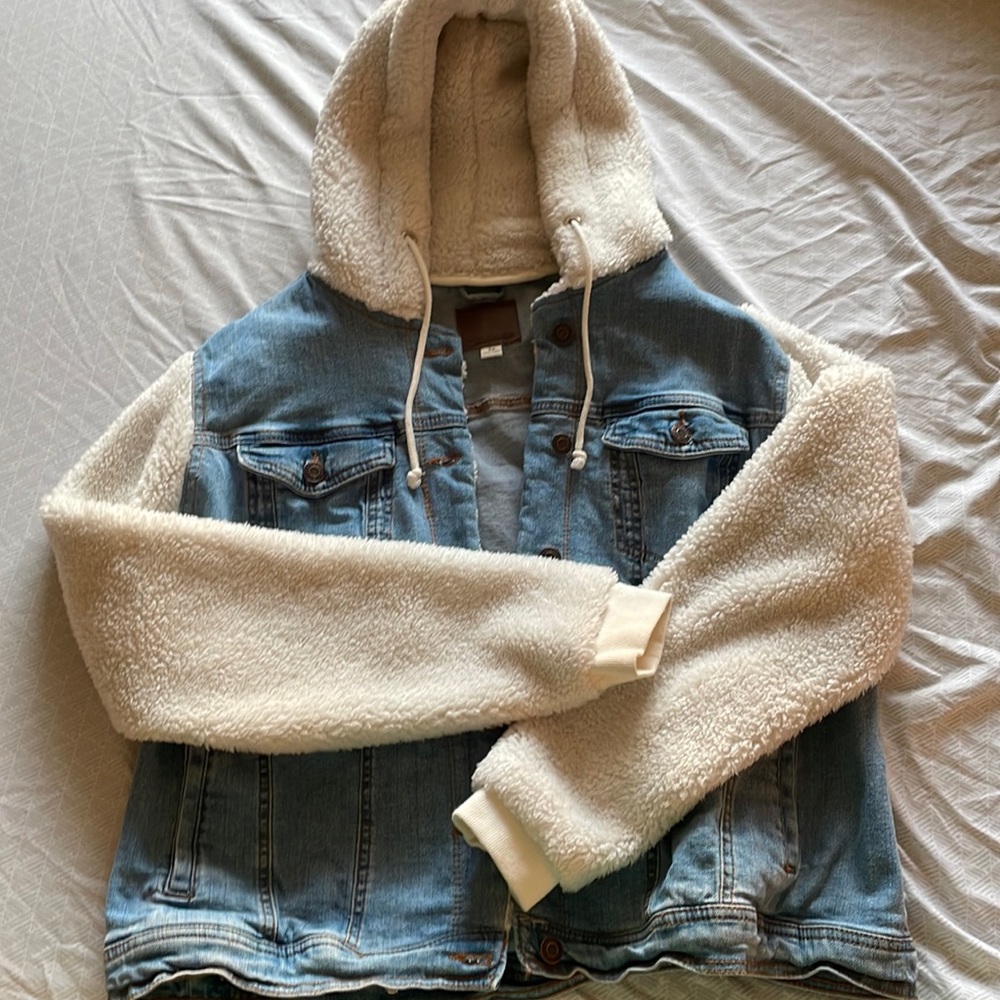 Jean jacket with Sherpa sleeves and hood.